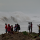 People stand watching the surf on the outskirts of Kingston, Jamaica on October 3rd. Image: AP
